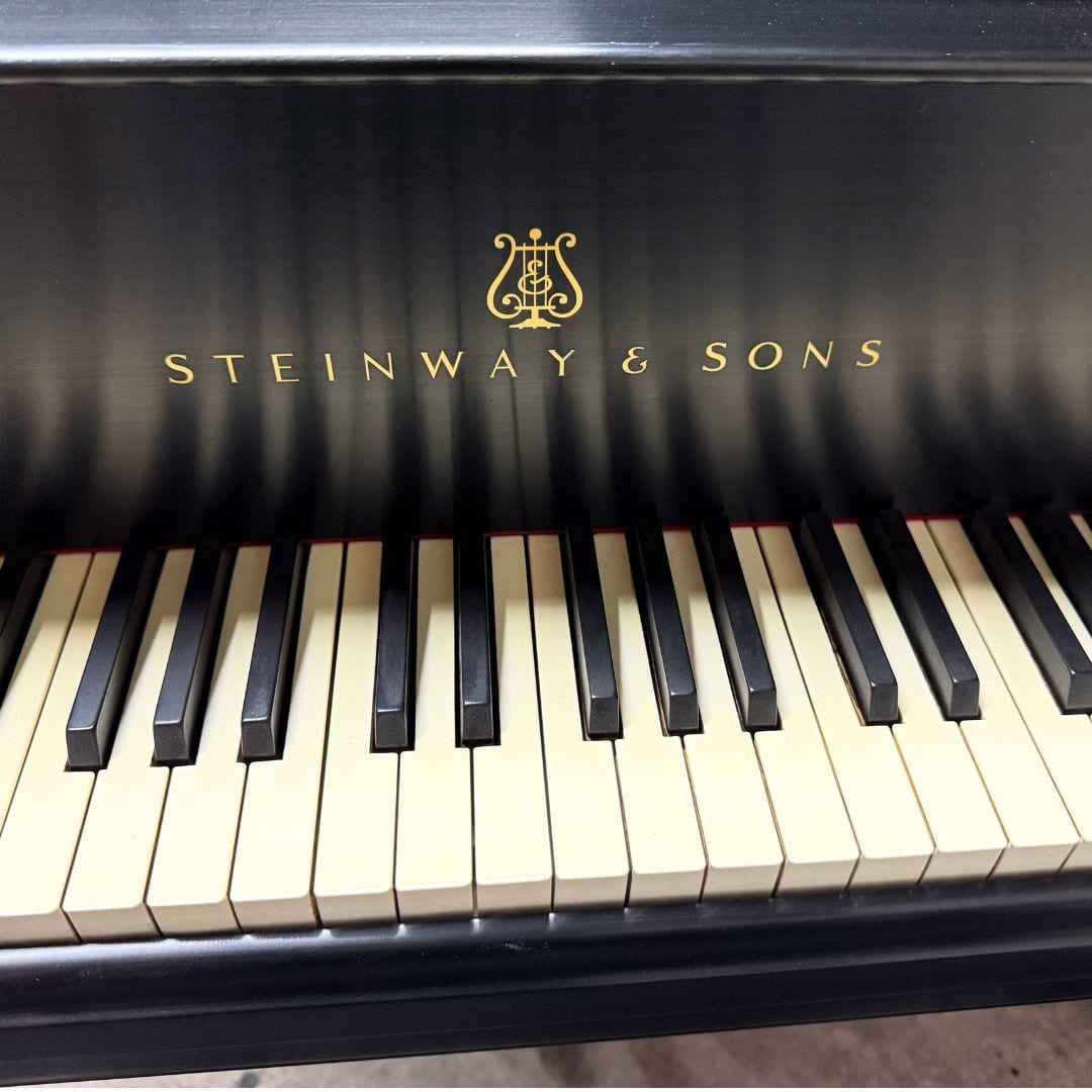 Close detail of the gold Steinway & Sons decal and the original ivory keytops